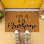 a welcome mat that says, come in we're awesome