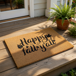 A textured door mat with the phrase "Happy fall y'all" printed on it.