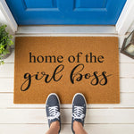 a door mat that says home of the girl boss