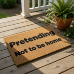 a textured doormat with the phrase "Pretending Not to be home" printed on it.