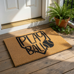 A door mat with the text "PLAY BALL" printed on it, featuring a baseball graphic.