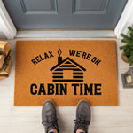 a door mat that says relax, we're on cabin time