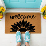 a welcome mat with a sunflower on it