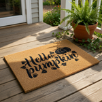 A textured door mat with the phrase "Hello pumpkin" printed on it, along with a pumpkin and autumn leaves.