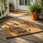 A textured doormat with the phrase "only my dog understands me" printed on it.