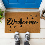 a welcome mat with a cat and paw prints