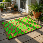 a rectangular door mat with a leaf pattern design.