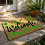 a welcome mat with the word "Welcome" written on it, surrounded by green shamrocks.