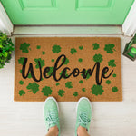 a welcome mat with shamrock leaves on it