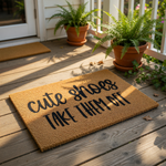 A textured doormat with the phrase "cute shoes take them off" printed on it.