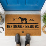 a rectangular door mat with a silhouette of a horse and the text "EST Bentbranch Meadows 2012" printed on it.