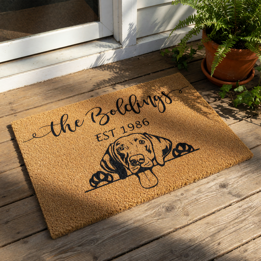The image is a rectangular, textured area rug with a black and white illustration of a dog's head peeking out from behind a wall.