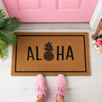 a door mat that says aloha with a pineapple on it