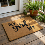A textured doormat with the phrase "HEY GIRL HEY" printed on it.