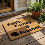 A textured area rug with the words "Faith, Family & Football" printed on it.