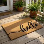A textured, beige-colored doormat with the word "Hello" written in a cursive font.