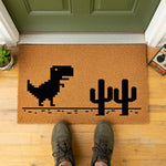 a door mat with a picture of a dinosaur on it