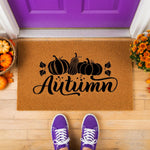 Autumn pumpkin doormat featuring a natural coir fiber texture with black script text and pumpkin illustrations, perfect for fall porch decor, seasonal entryway rugs, and farmhouse style outdoor welcome mats for your front door.
