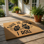 This is How I Roll Hanukkah doormat featuring two spinning dreidels in black ink on a natural coir fiber welcome mat, perfect for holiday home decor, front porch entryways, and festive seasonal floor mats for your house entrance.