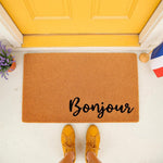 Bonjour coir doormat for front porch entry, featuring a natural fiber welcome mat with black script text.