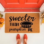 Sweeter Than Pumpkin Pie doormat featuring a festive fall design on natural coir fiber, perfect for autumn porch decor with its seasonal typography and pie graphic, creating a cozy welcome mat for your front door entrance this
