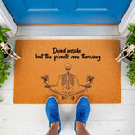 Funny skeleton doormat with the text Dead inside but the plants are thriving, featuring a yoga pose illustration on a natural coir welcome mat for a front porch, perfect for plant lovers and those who enjoy dark humor home decor.