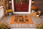 Funny coir doormat for front porch featuring the text Home is where the ho and me come together, a cheeky welcome mat for housewarming or home decor that adds a humorous touch to your entryway floor with its natural fiber design.