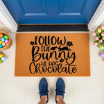 Follow the Bunny He Has Chocolate Easter doormat featuring a cute rabbit graphic on natural coir fiber, perfect for spring porch decor, front door entryways, and seasonal home welcome mats for a festive holiday house entrance.