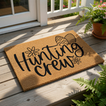 Hunting Crew Easter doormat featuring a natural coir welcome mat with black text and decorative egg and flower illustrations, perfect for spring porch decor and seasonal entryway floor mats for a festive holiday home entrance.