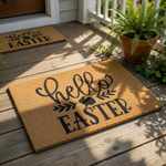 Hello Easter coir doormat with a cute bunny rabbit silhouette and leaf accents, featuring black script and block lettering on a natural brown fiber welcome mat for spring holiday home porch decor and seasonal entryway floor mats.