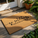 No soliciting dog doormat with funny paw print design, this natural coir fiber welcome mat features black text reading no soliciting please see dogs for details, a humorous front porch decor piece for pet lovers and home security.