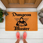 Dungeon Master doormat for tabletop gaming fans, featuring a hooded figure reading a book with dice icons on an orange welcome mat, perfect for a front porch entrance to a home gaming room or a fantasy themed house decor setup.