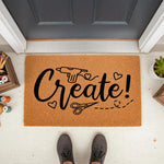 Craft room doormat with Create text and glue gun scissors design on natural coir fiber.
