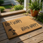 Tropical beach happy doormat with palm tree design on natural coir fiber, a funny outdoor welcome mat for summer porch decor that says don't worry beach happy in black script, perfect for coastal home entryways and patio floor