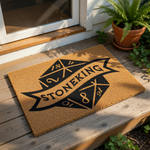 Personalized family name coir doormat featuring a custom banner design on a natural fiber welcome mat, perfect for front porch decor and housewarming entryways, displayed on a wood deck with a potted plant nearby for a rustic