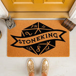Personalized tabletop gaming doormat featuring a large twenty-sided die graphic and a banner for a family name, this durable coir welcome mat is a fun home decor choice for any fantasy roleplaying game fan and their entryway.