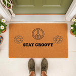 Stay Groovy doormat with a peace sign and flower design, this natural fiber welcome mat features a retro 70s style print for your front porch decor, creating a fun and inviting entryway for guests at your home or apartment door.
