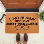 Funny optician doormat with the text I Can't Fix Crazy But I Can Adjust Your Glasses, featuring a pair of glasses icon on a natural coir welcome mat for a front porch, perfect for an optometrist or eye doctor office entrance