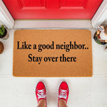 Funny doormat with the text Like a good neighbor stay over there, a natural coir welcome mat for front porch decor that adds humor to your entryway, featuring a durable fiber construction for outdoor use at your home or apartment