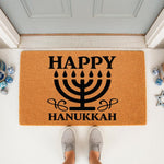 Happy Hanukkah doormat featuring a black menorah design on a natural coir welcome mat, perfect for holiday porch decor and front door entryways to celebrate the festival of lights with festive seasonal floor mat style.
