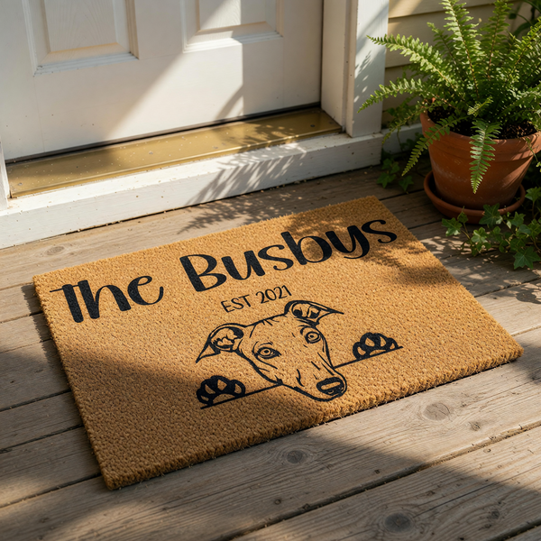 Personalized Greyhound doormat featuring a custom family name and established year, this natural coir welcome mat displays a cute dog peeking over the edge, making it a stylish front porch decor piece for any dog lover home