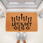 Hanukkah doormat with Let's Get Lit text and menorah candles, this natural coir welcome mat features a festive holiday design for your front porch decor, perfect for Jewish holiday home entryways and seasonal floor mat styling.