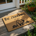 Personalized family name doormat featuring a cute Golden Retriever dog peeking over the bottom edge, this custom coir welcome mat is a durable outdoor floor rug for pet lovers and makes a great housewarming gift for new