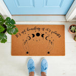 Plant lover welcome doormat with celestial moon phase design and hands holding stars, featuring the text It's not hoarding if it's plants on a natural coir fiber mat, perfect for a houseplant enthusiast front porch decor entry