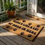 Funny dog doormat with paw prints and the text There's Like A Lot Of Dogs In Here, this natural coir fiber welcome mat is a durable outdoor floor rug for pet lovers and dog owners looking for a humorous home entrance decor