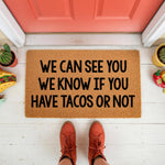 Funny taco doormat with the text We Can See You We Know If You Have Tacos Or Not, a natural coir fiber welcome mat for front porch decor, featuring a humorous food quote design that makes a great housewarming gift for taco lovers.