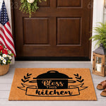Bless This Kitchen doormat featuring a black cooking pot design on natural coir fiber, this farmhouse style welcome mat is a durable outdoor floor rug for your front porch entry, home decor, or housewarming gift for a new home