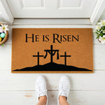 a door mat with the words he is risen on it