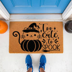 Halloween cat pumpkin doormat featuring a cute black kitten in a witch hat, perfect for fall porch decor.