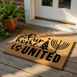 Holiday welcome doormat featuring the text Our home is UNITED with a Christmas tree and a menorah icon, perfect for a seasonal front porch rug or entry mat that celebrates winter festivities and diverse family traditions.